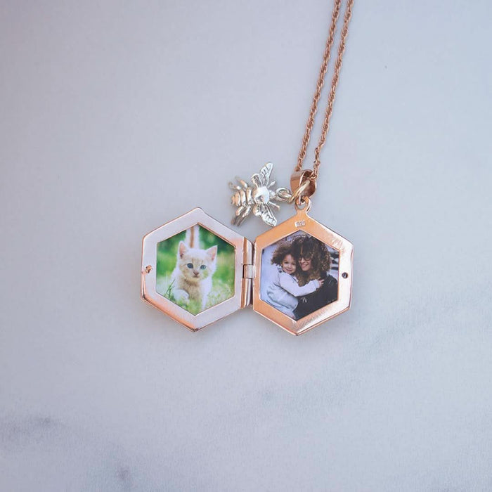 opened bee locket in rose gold with family photos inside