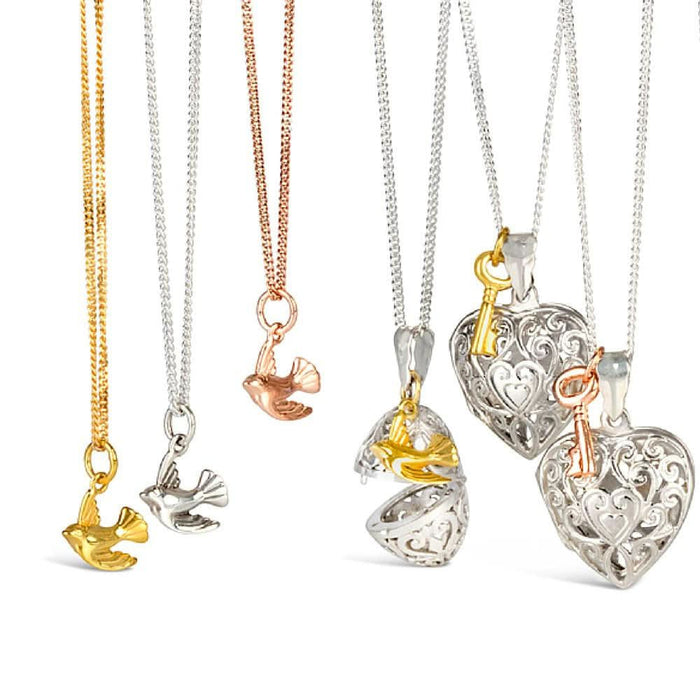 three bird pendants next to bird and key lockets
