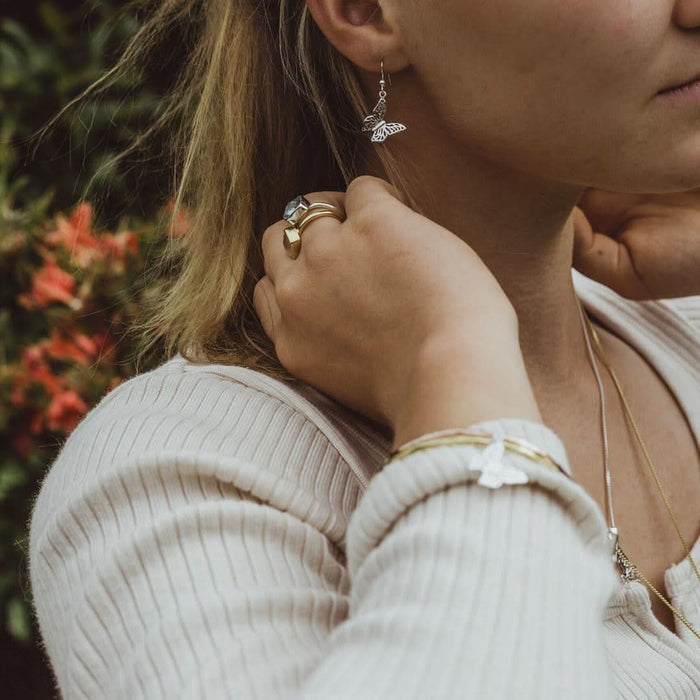 close up of model wearing butterfly bangle