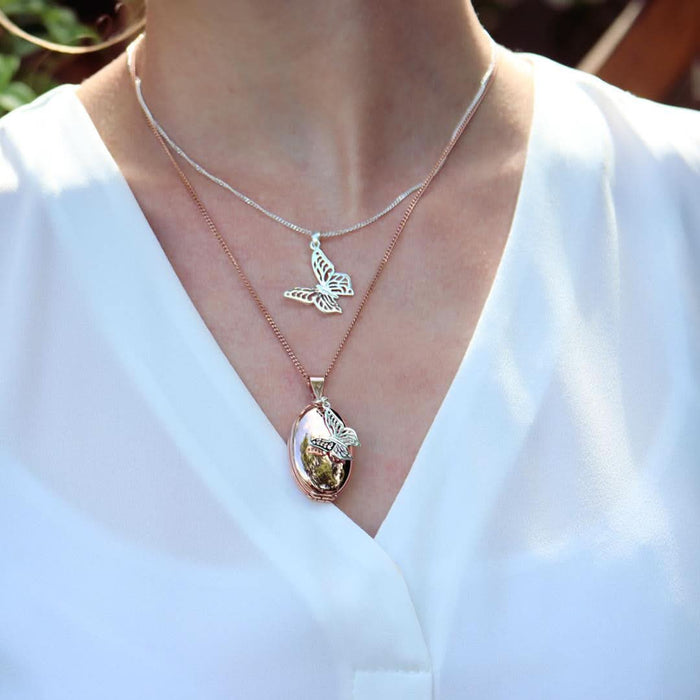 model wearing butterfly pendant in silver