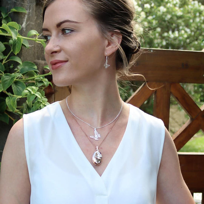 model wearing silver butterfly pendant