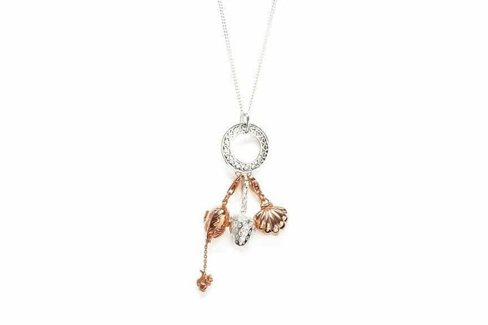 charm carrier pendant with three magical charms attached