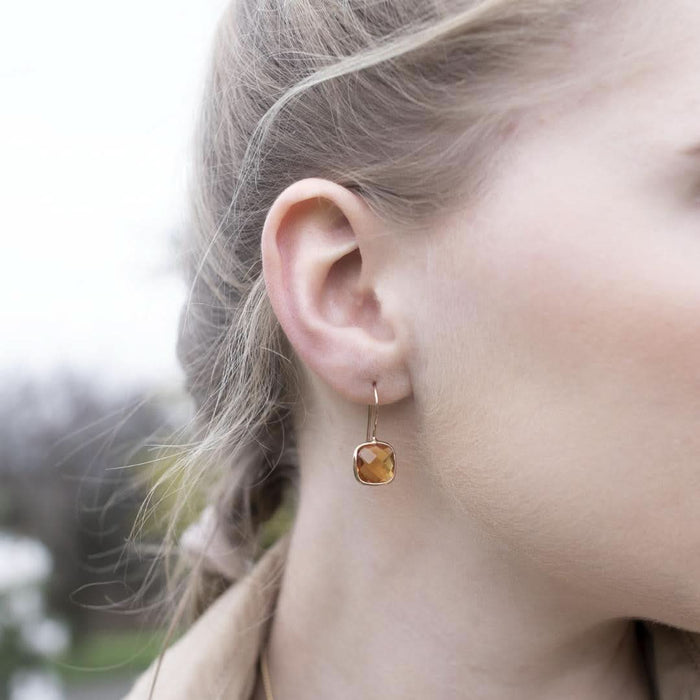 Close up of model wearing citrine earrings