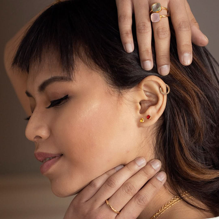 Model image wearing citrine mini stud earrings in gold