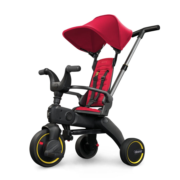 A red Doona Liki Trike S1 for children, featuring a black frame, yellow wheels, and a sunshade. It is designed for multiple stages of growth for a child.