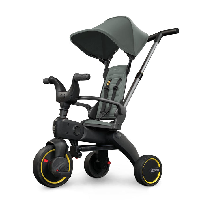 Children's tricycle with seat and canopy on a white background