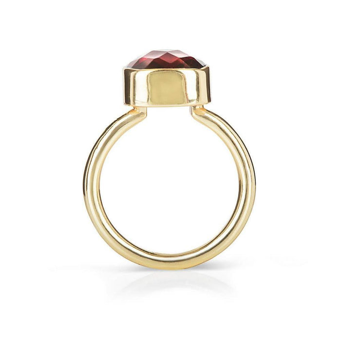 garnet cocktail ring in gold on a white background