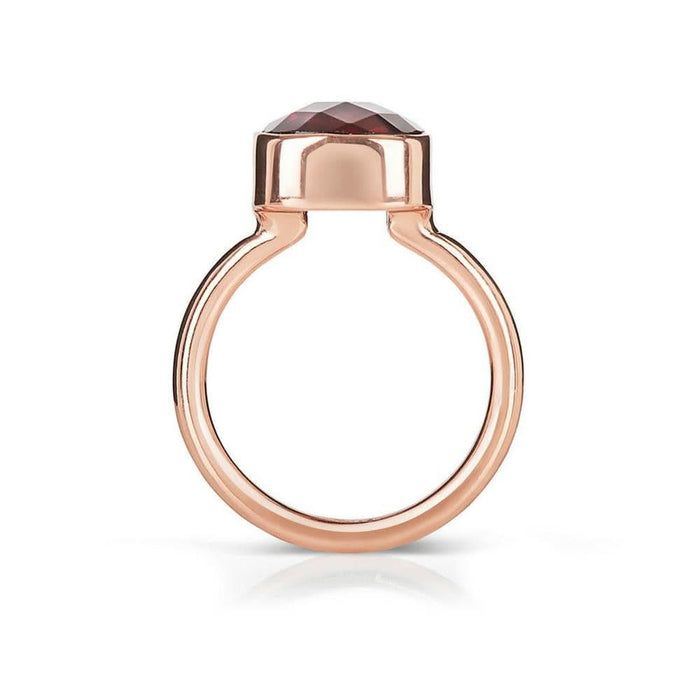 garnet cocktail ring in rose gold on a white background