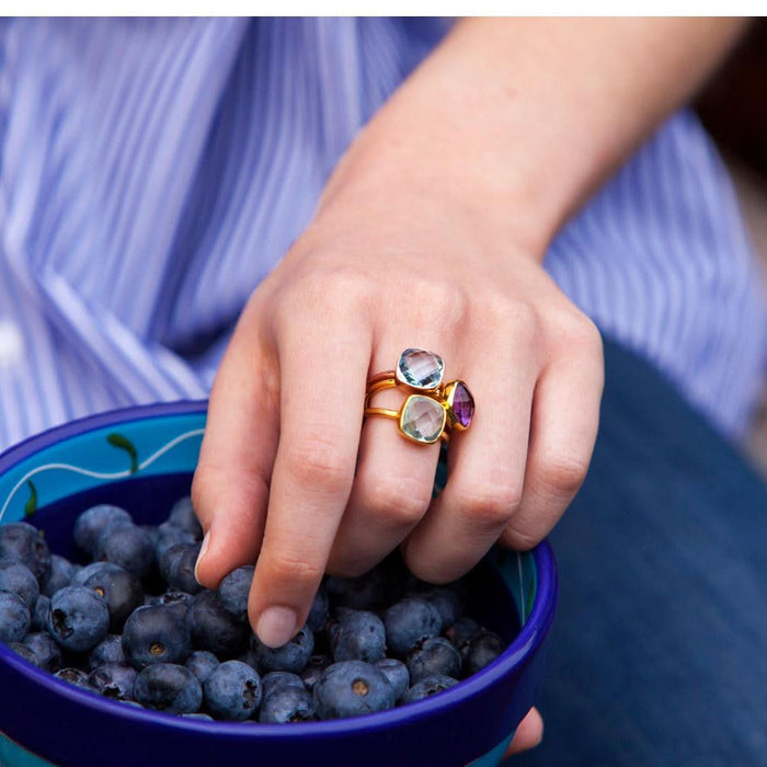 model wearing three cocktail rings in gold