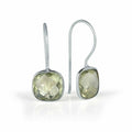 green amethyst earrings in silver on a white background