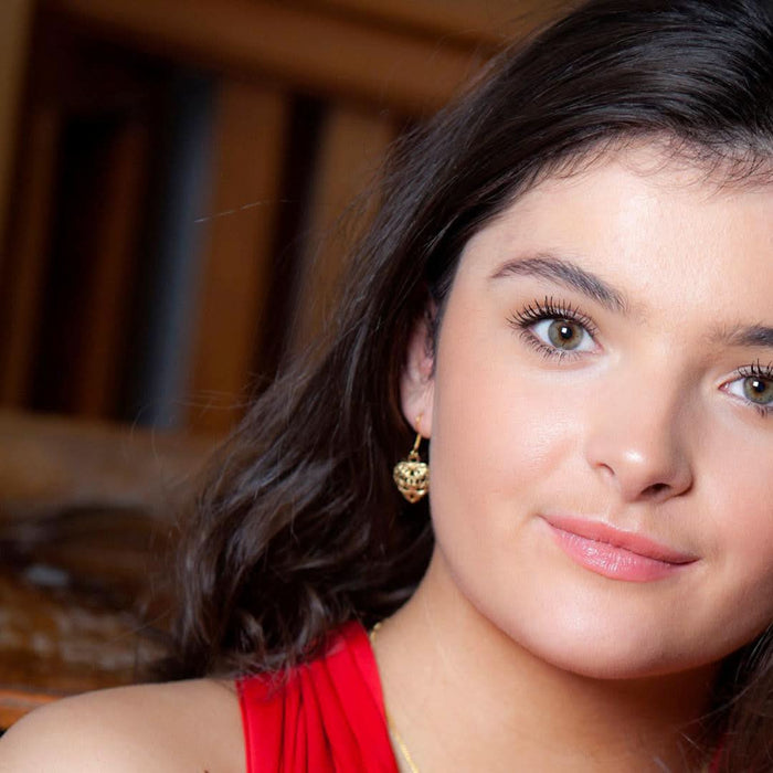 model wearing heart earrings in gold