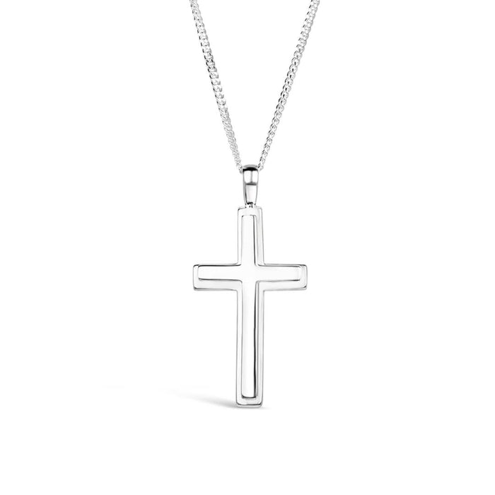 A heavyweight silver cross necklace for men hanging on a curb chain against a white background