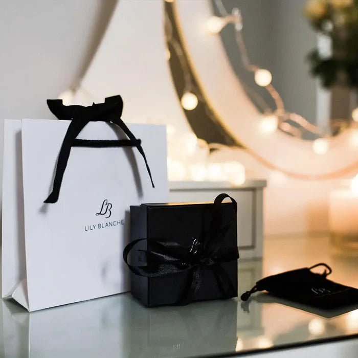 Luxury jewellery gift packaging with ribbon-tied box and Lily Blanche gift bag, elegant ready-to-gift presentation