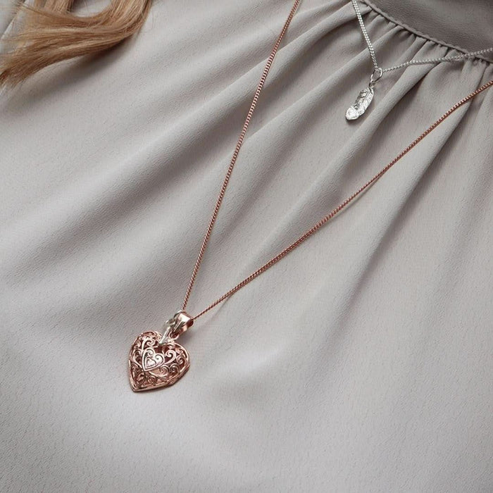 close up of model wearing rose gold key locket