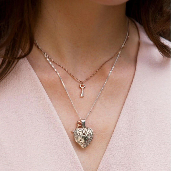 model wearing key pendant along with key locket