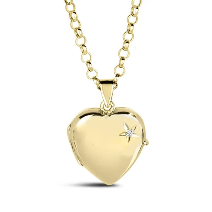 Closed gold heart locket necklace by Lily Blanche, with a small diamond accent in a starburst design on the front, hanging from a gold chain.