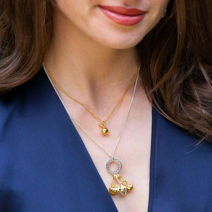 model wearing magical charms attached to necklace