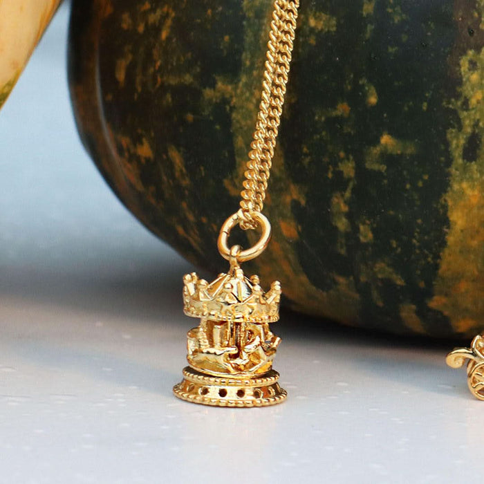 gold charm necklace with carousel