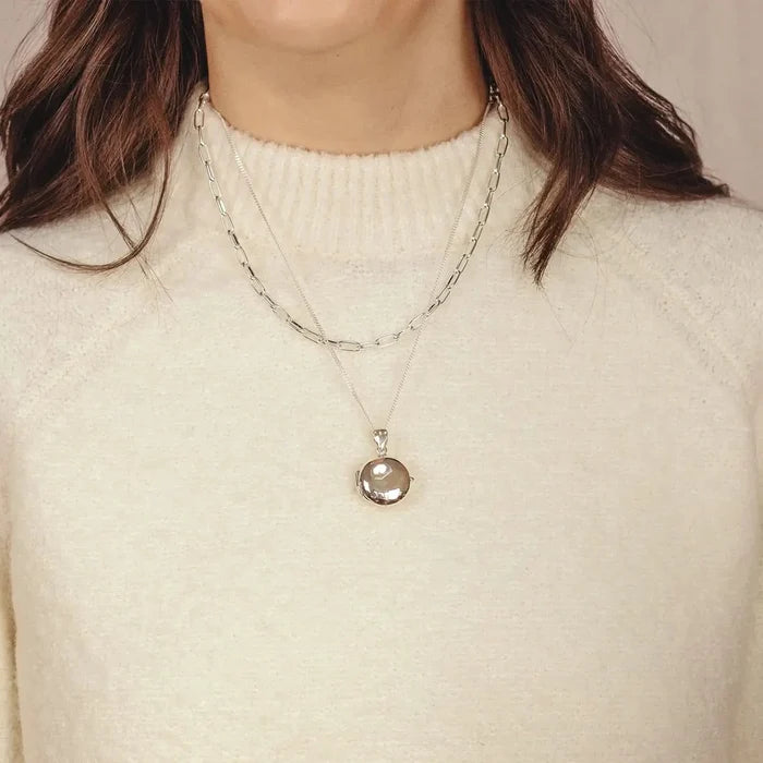 woman wearing Silver round Necklace for ashes, memorial necklace, locket with one photo and ashes storage, silver curb chain, engraving, silver paperclip chain