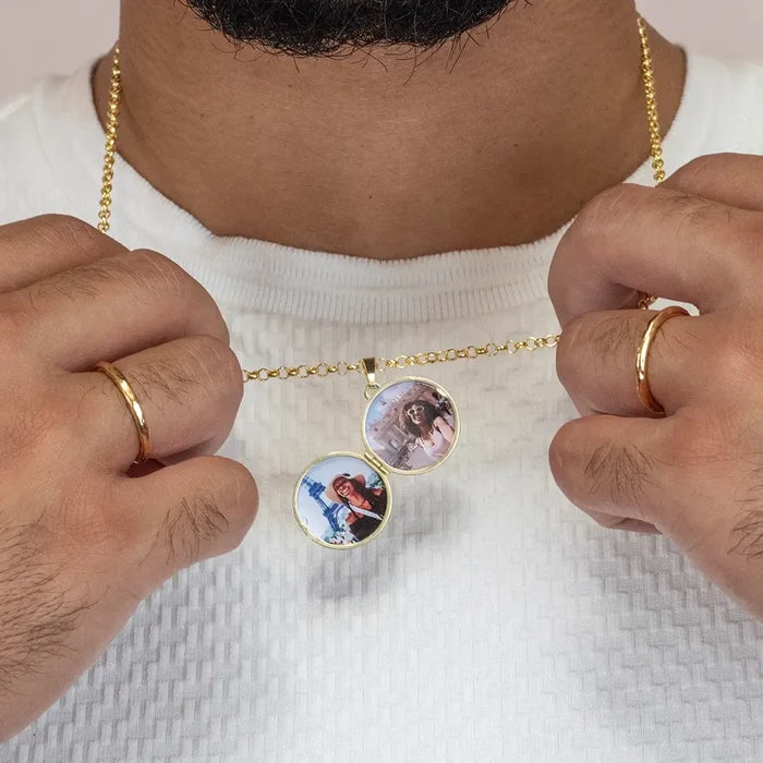 Men’s gold locket necklace opened to reveal two personalised photo inserts, worn with white textured top
