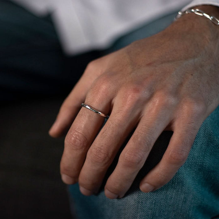closeup of model wearing men's hammered ring in sliver