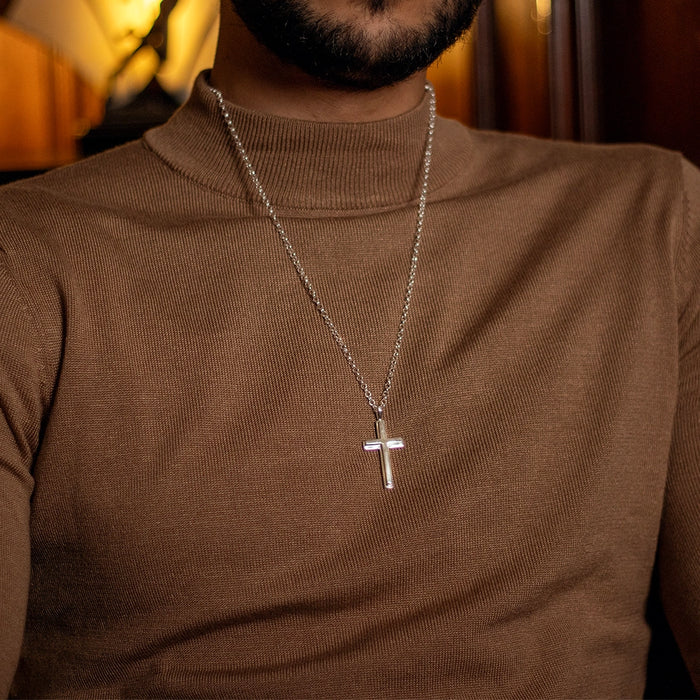 Sterling silver cross pendant necklace on chain, men’s jewellery worn by model in brown sweater. By Lily Blanche.