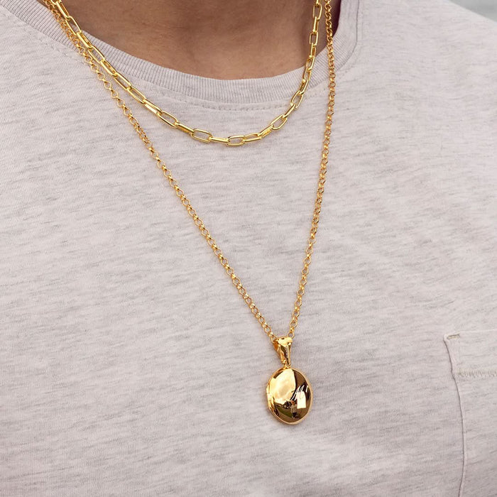 model wearing men's round locket necklace