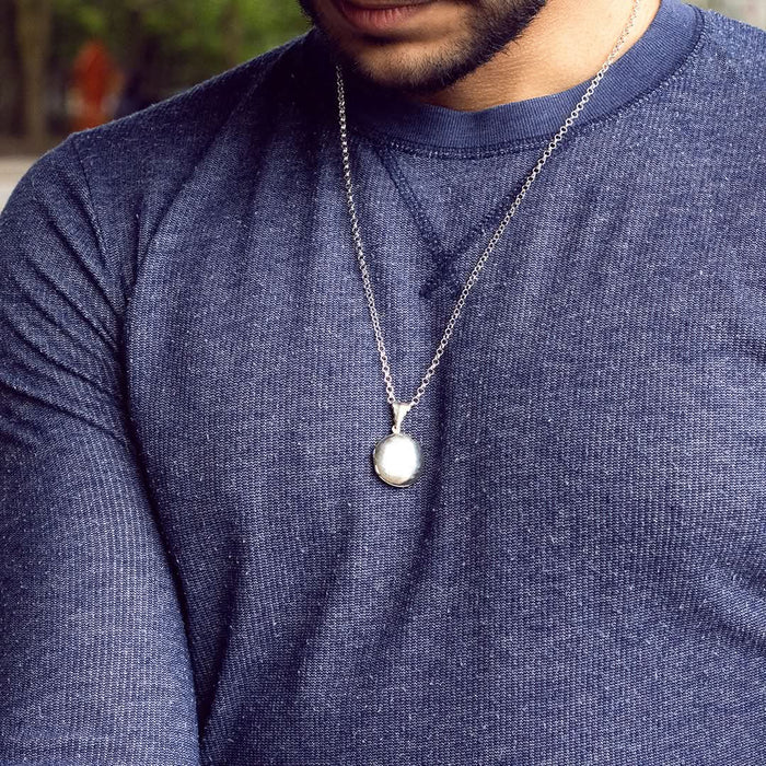 model wearing men's round locket necklace in white gold