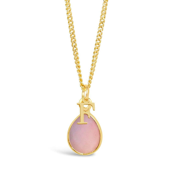 pink opal charm necklace in gold with initial charm on a white background