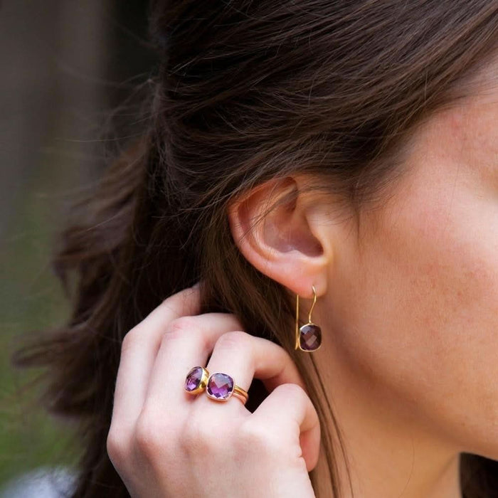 model wearing purple amethyst cocktail ring in rose gold with matching earrings
