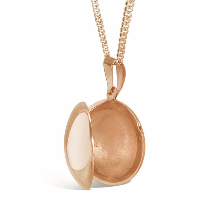 round locket necklace in rose gold on a white background