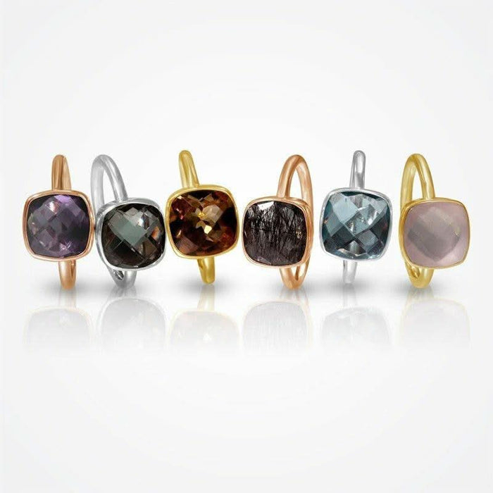 collection of cocktail rings with different gemstones on a white background