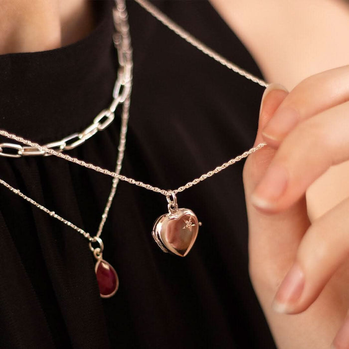 Model wearing the small sterling silver 2 Photo Diamond Heart Locket on a rope chain