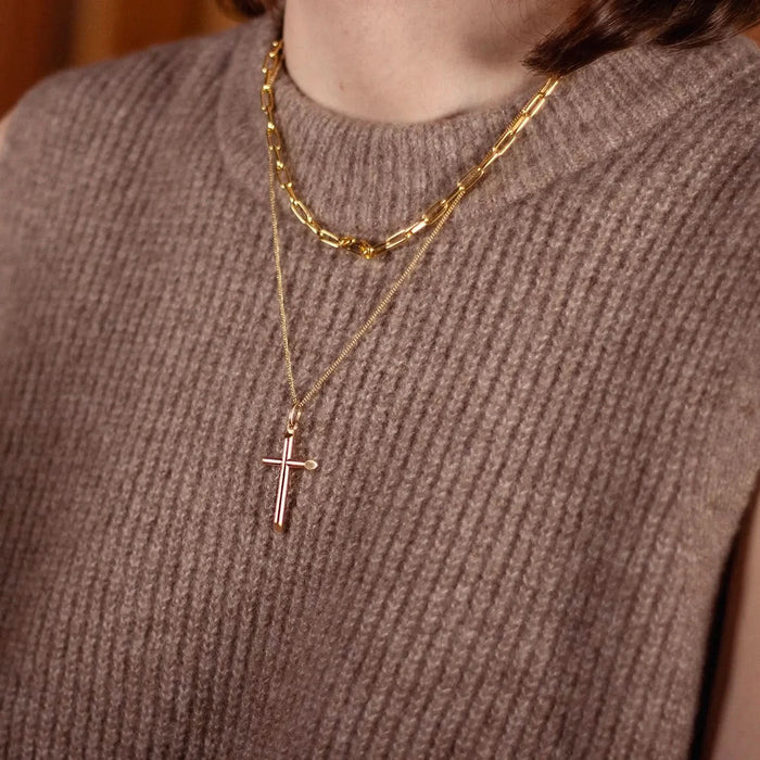 model wearing gold cross necklace with chain