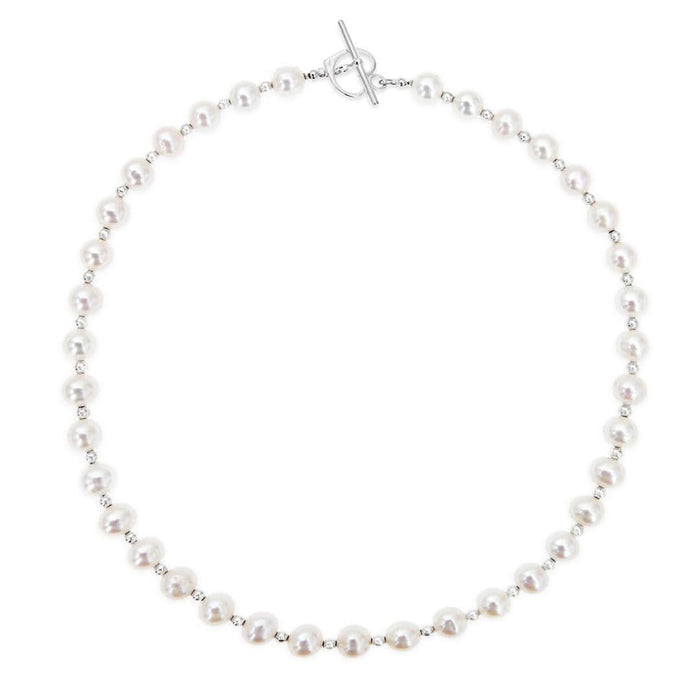 A sterling silver necklace featuring freshwater pearls and sterling silver balls, with a sterling silver heart clasp.