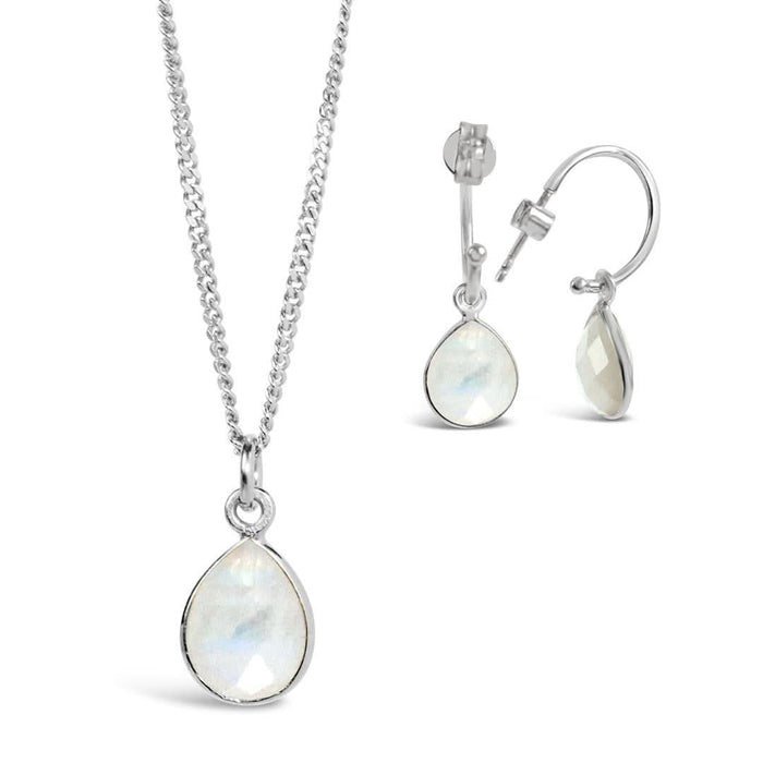 white quartz charm necklace and drop hoop earrings in silver on a white background