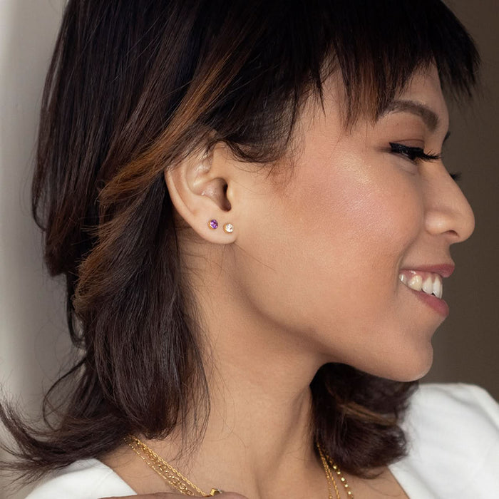 Close up model image wearing white quartz mini stud in rose gold